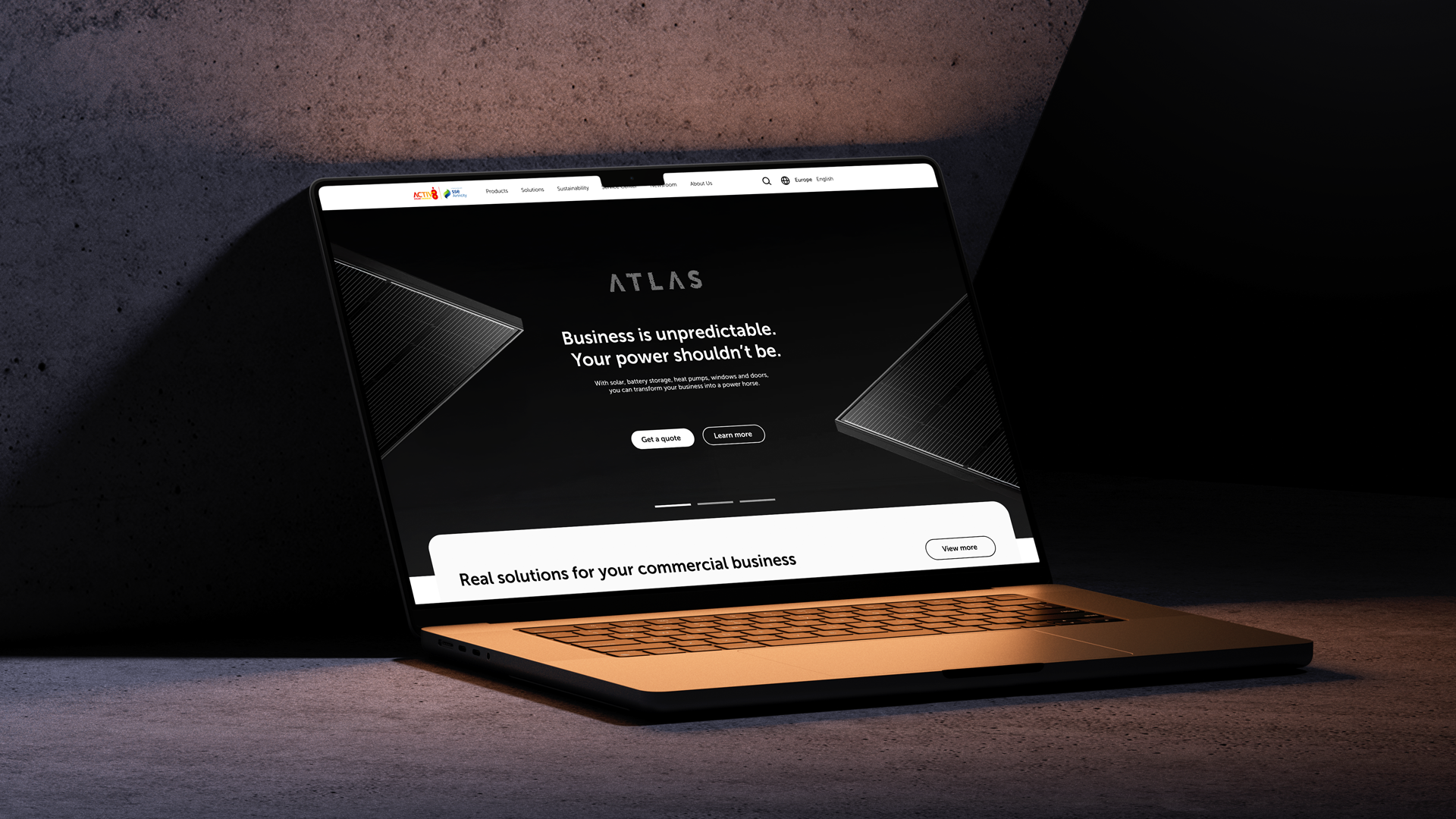 Laptop showing the Atlas commercial website homepage: 'Business is unpredictable. Your power shouldn't be.'
