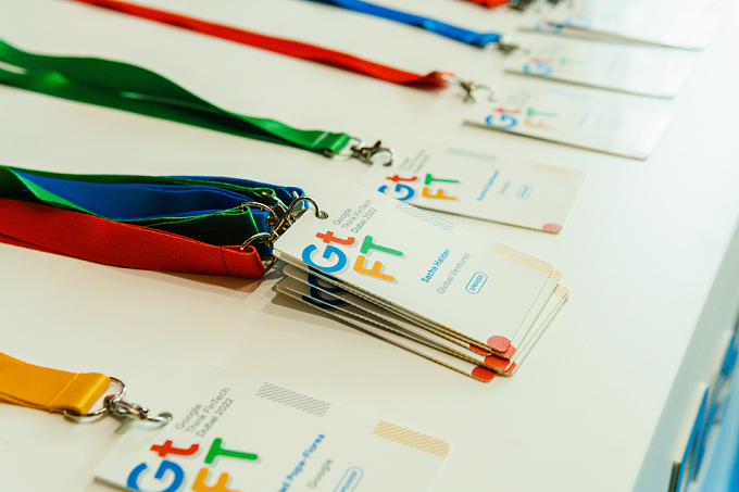 Colour-coded lanyards and event badges laid out on a table