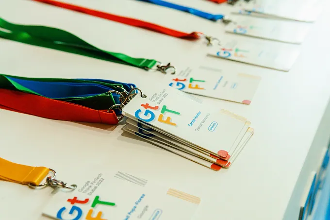 Colour-coded lanyards and event badges laid out on a table
