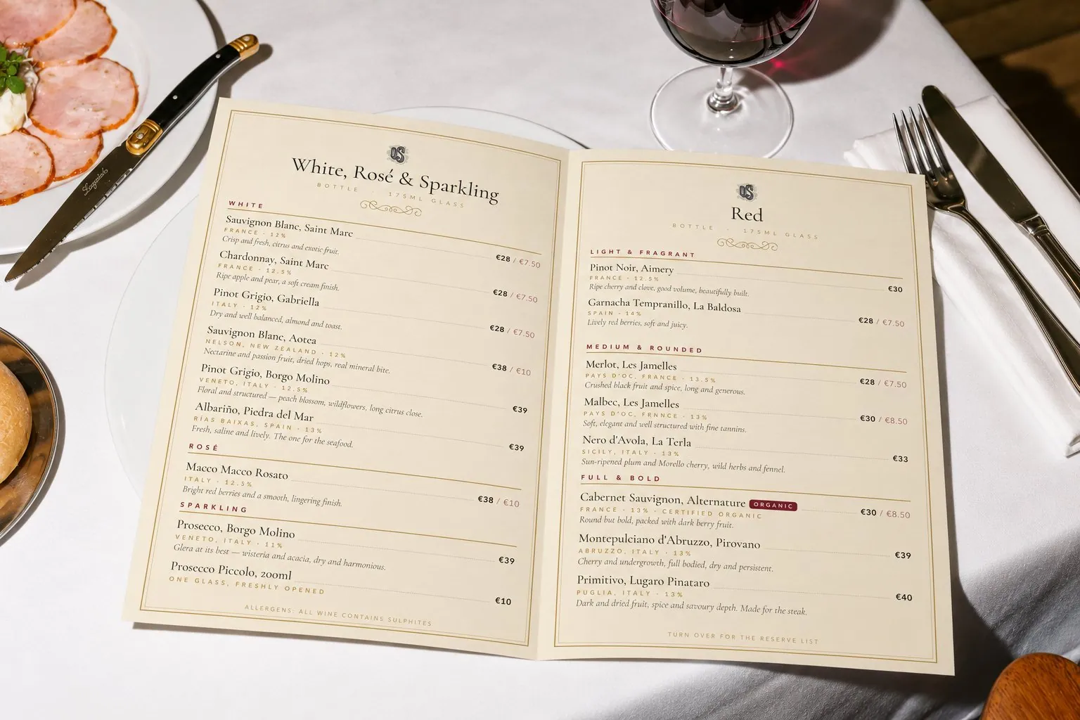 The O'Sullivans wine list open on a restaurant table, with whites, rosé and sparkling on the left page and reds on the right